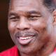 Herschel Walker, the Republican nominee for the state’s U.S. Senate seat, takes questions from the media after a campaign event July 20, 2022, in Athens, Ga. A new report says Georgia Republican Senate nominee Herschel Walker paid for an abortion for his girlfriend in 2009. Walker has vehemently opposed abortion rights and calls the accusation in The Daily Beast a “flat-out lie.” The Daily Beast spoke to a woman who said Walker paid for her abortion when they were dating.
